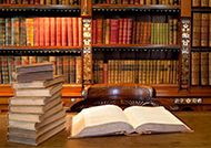 Library with book open and books in background